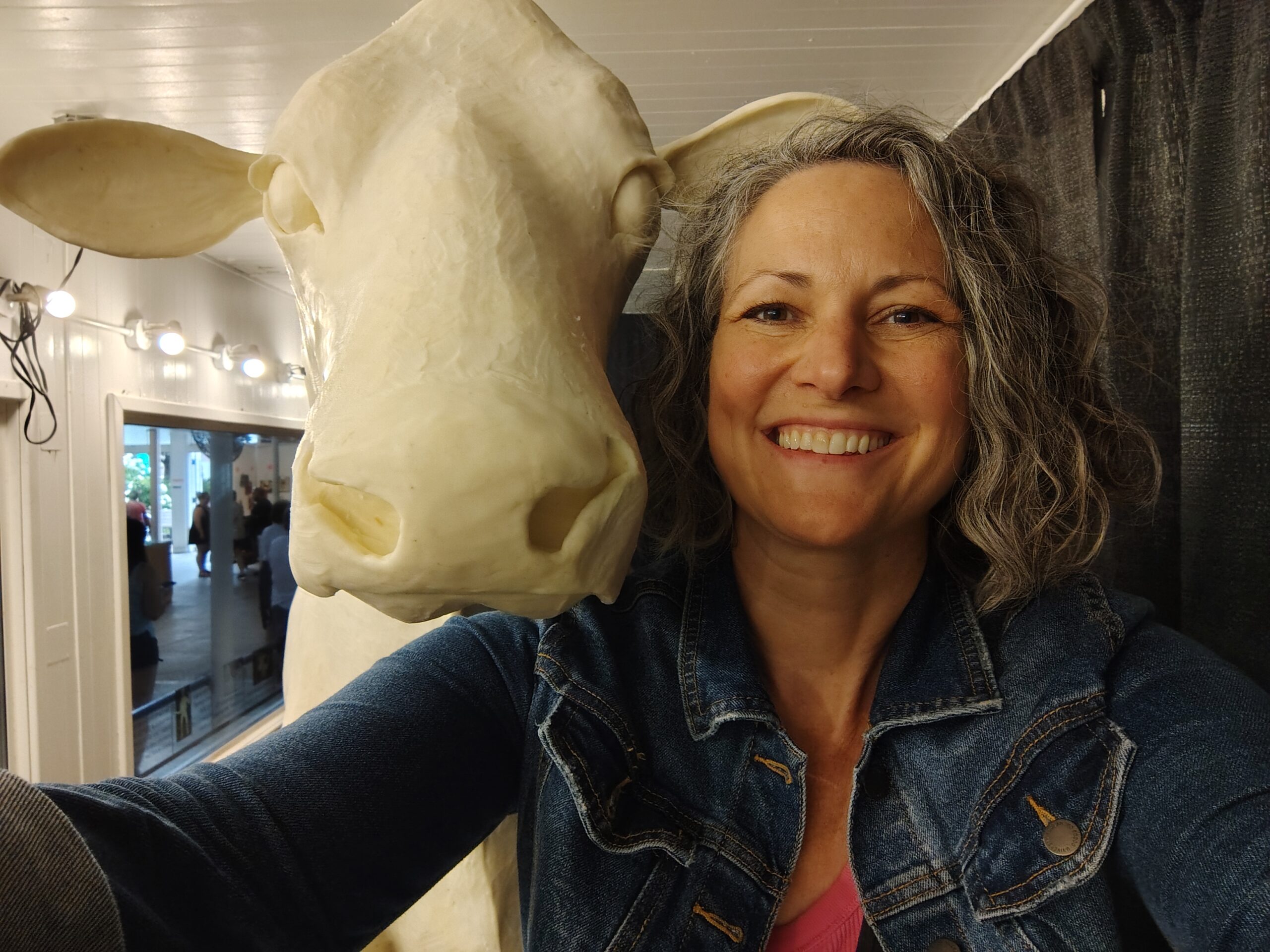 Sarah Pratt poses for a photo with the Iowa State Fair butter cow